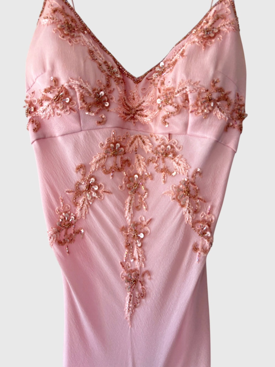 Close-up floral embroidery beads and sequins on pink silk gown