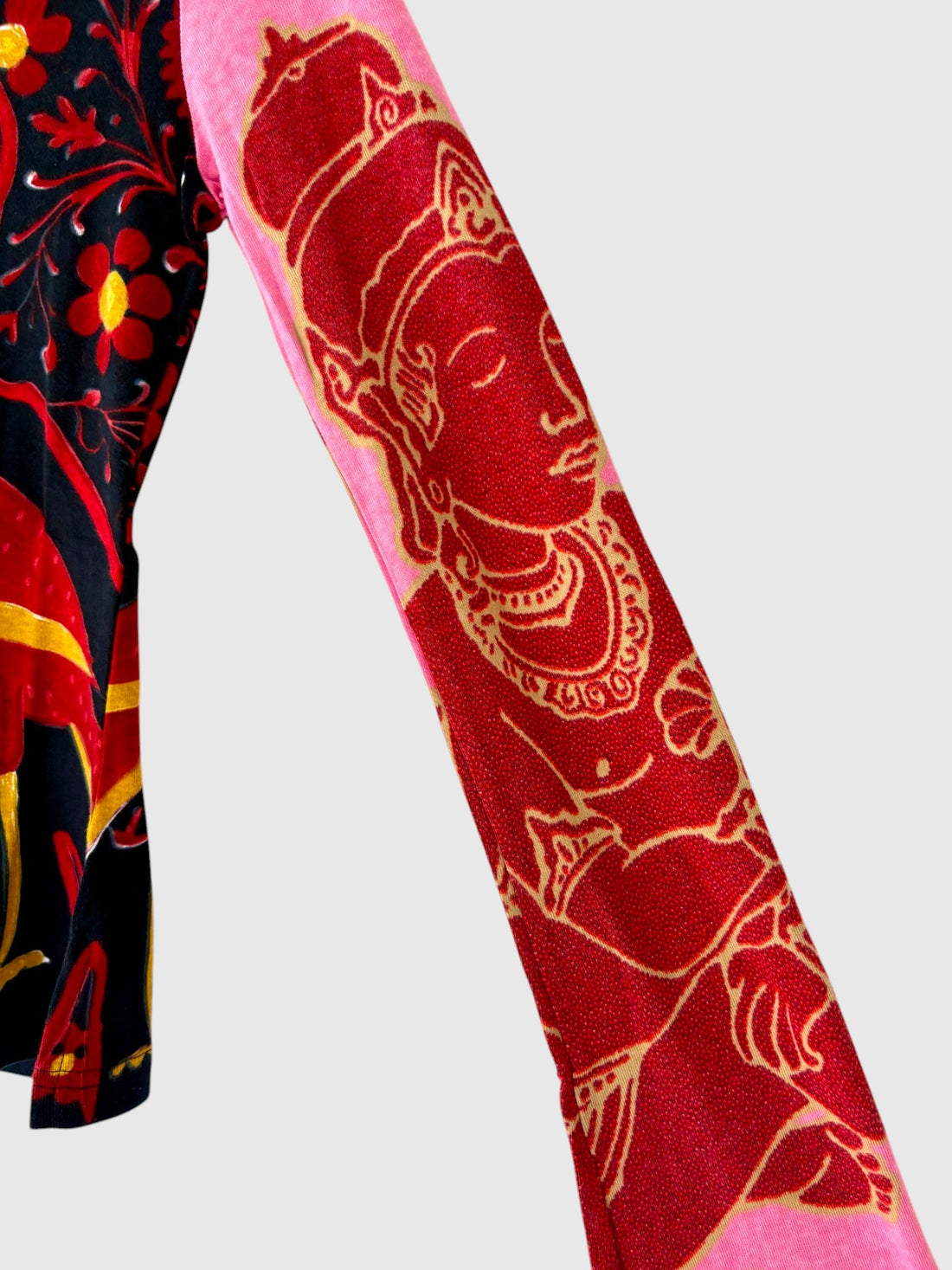 Close-up of colorful ornamental artwork and fine printed details on pink sleeve of Custo Barcelona vintage graphic shirt