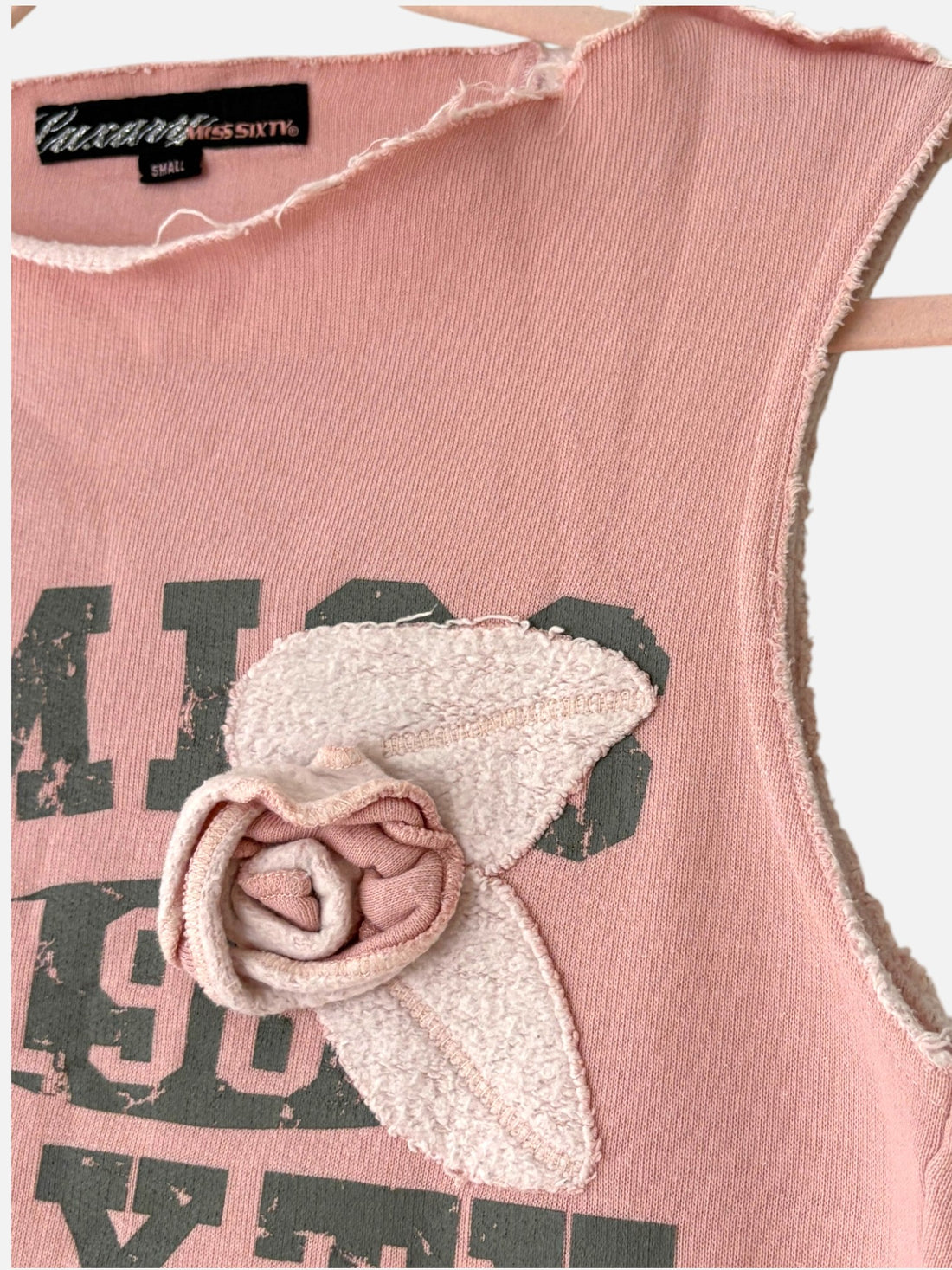 Close-up of oversized flower appliqué on vintage Miss Sixty pink tank