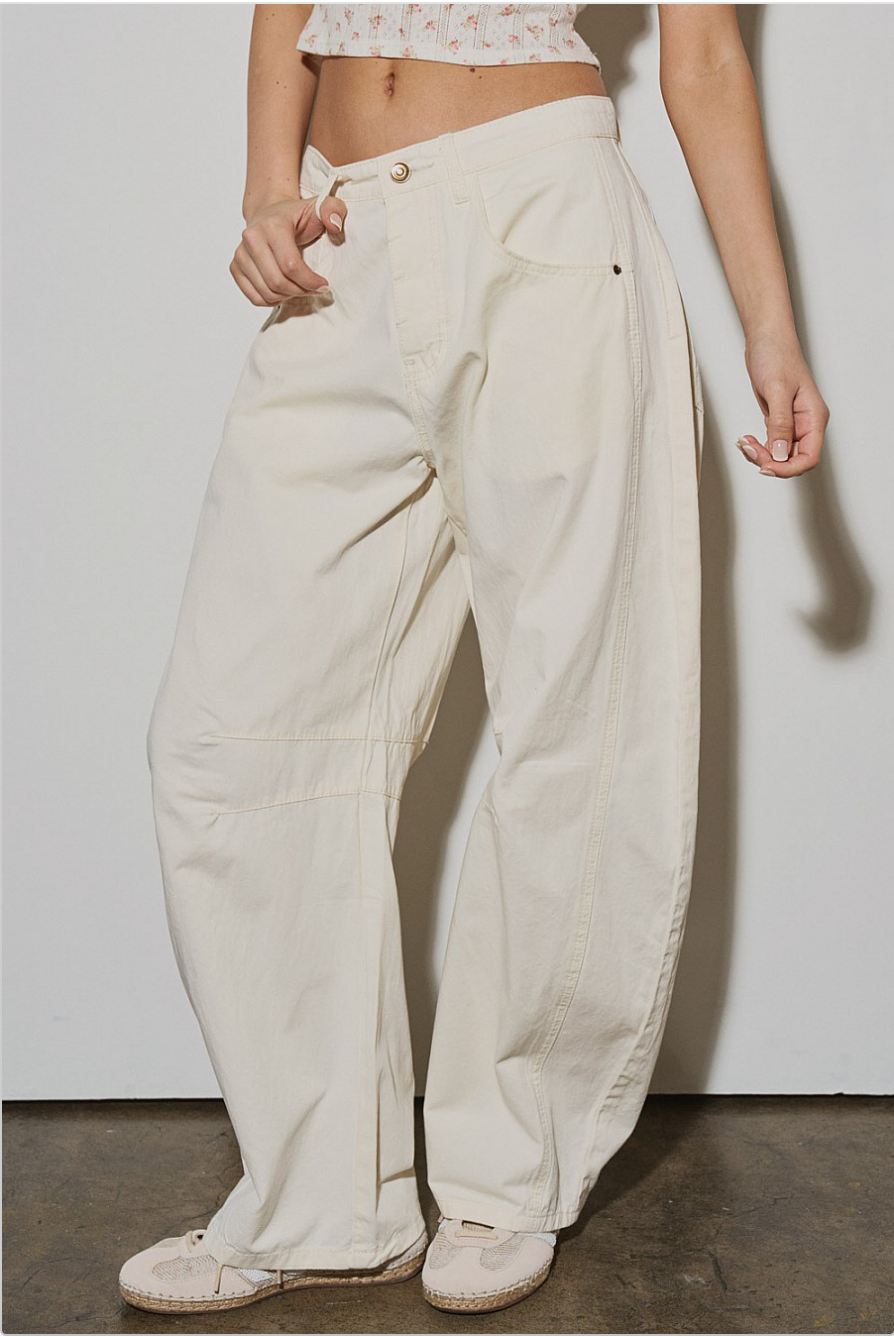 Angled view of Off-Duty Barrel Pant in ecru with relaxed barrel fit and oversized pocket detail.