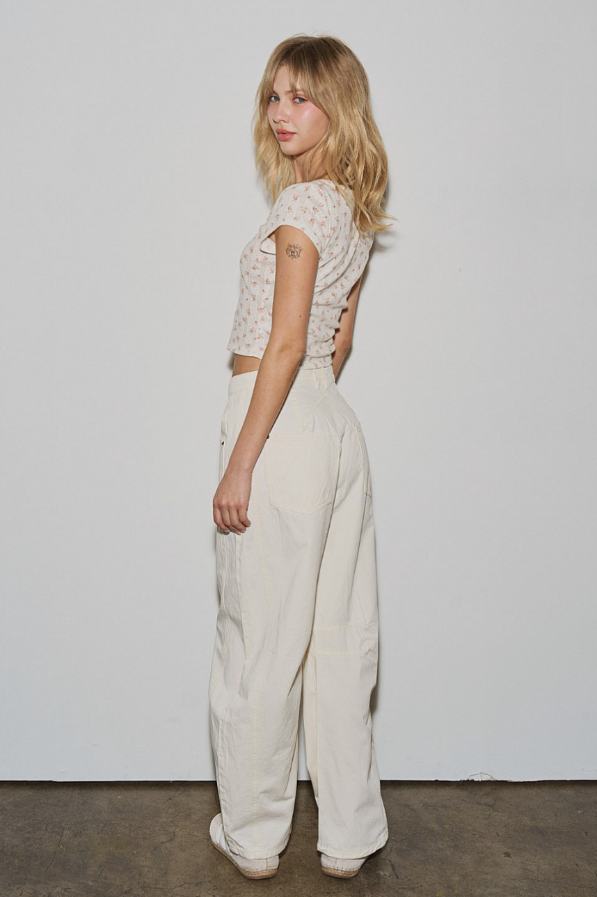 Side/back view of Off-Duty Barrel Pant in ecru showing relaxed barrel-leg shape and rear pocket.