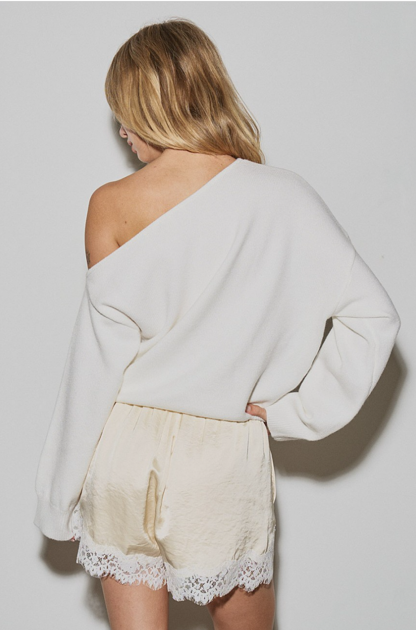 Back view of butter yellow woven satin shorts with lace trim.