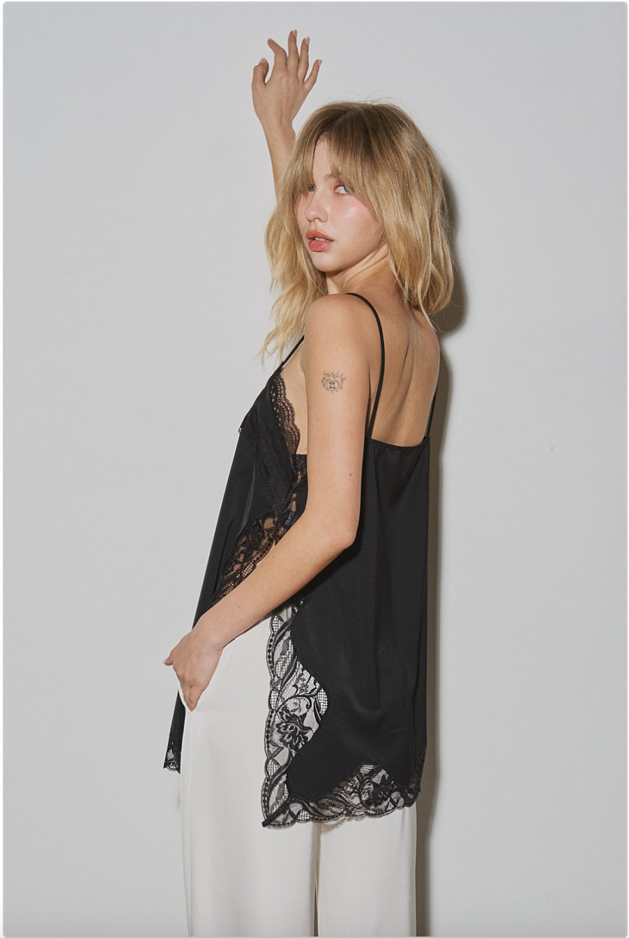 Side view of black lace-trim camisole showing lace inset at side slit.