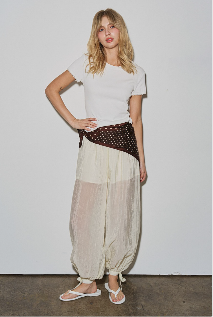 Front view of Willow Balloon Pant on model, elastic waist and balloon silhouette with ankle ties.