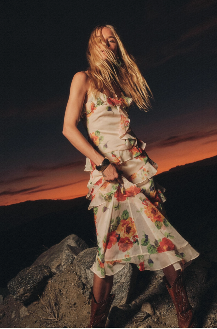 Floral chiffon asymmetrical ruffle maxi dress with side slit, styled outdoors at sunset with western boots