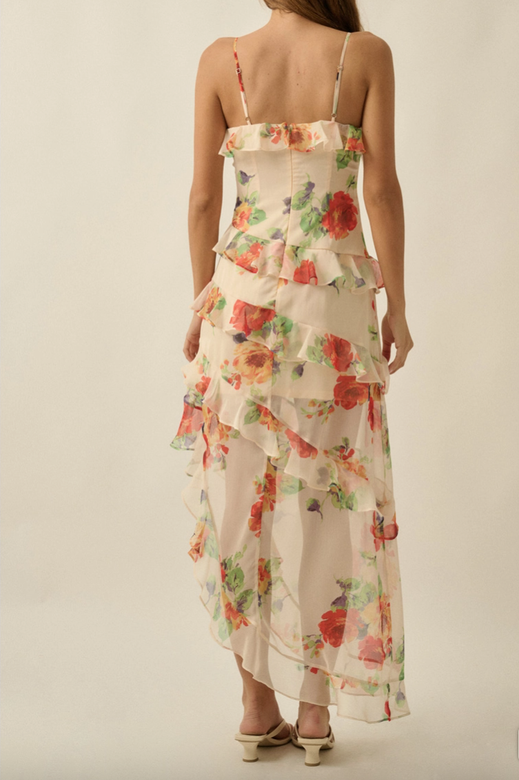 Back view of floral chiffon maxi dress with low back and adjustable straps, featuring layered ruffle skirt