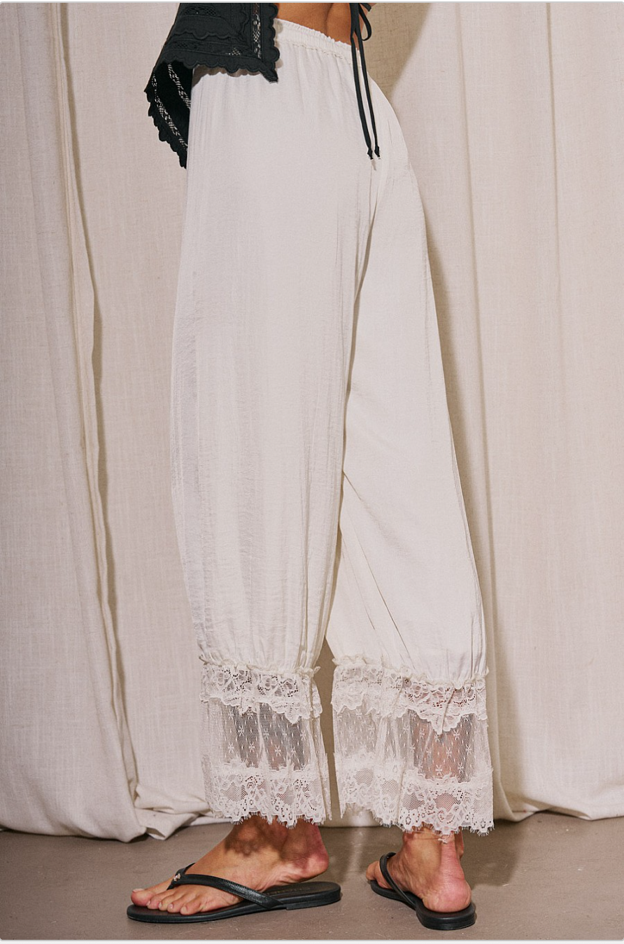 Back view of romantic ivory lounge pants with sheer white lace ankle panels