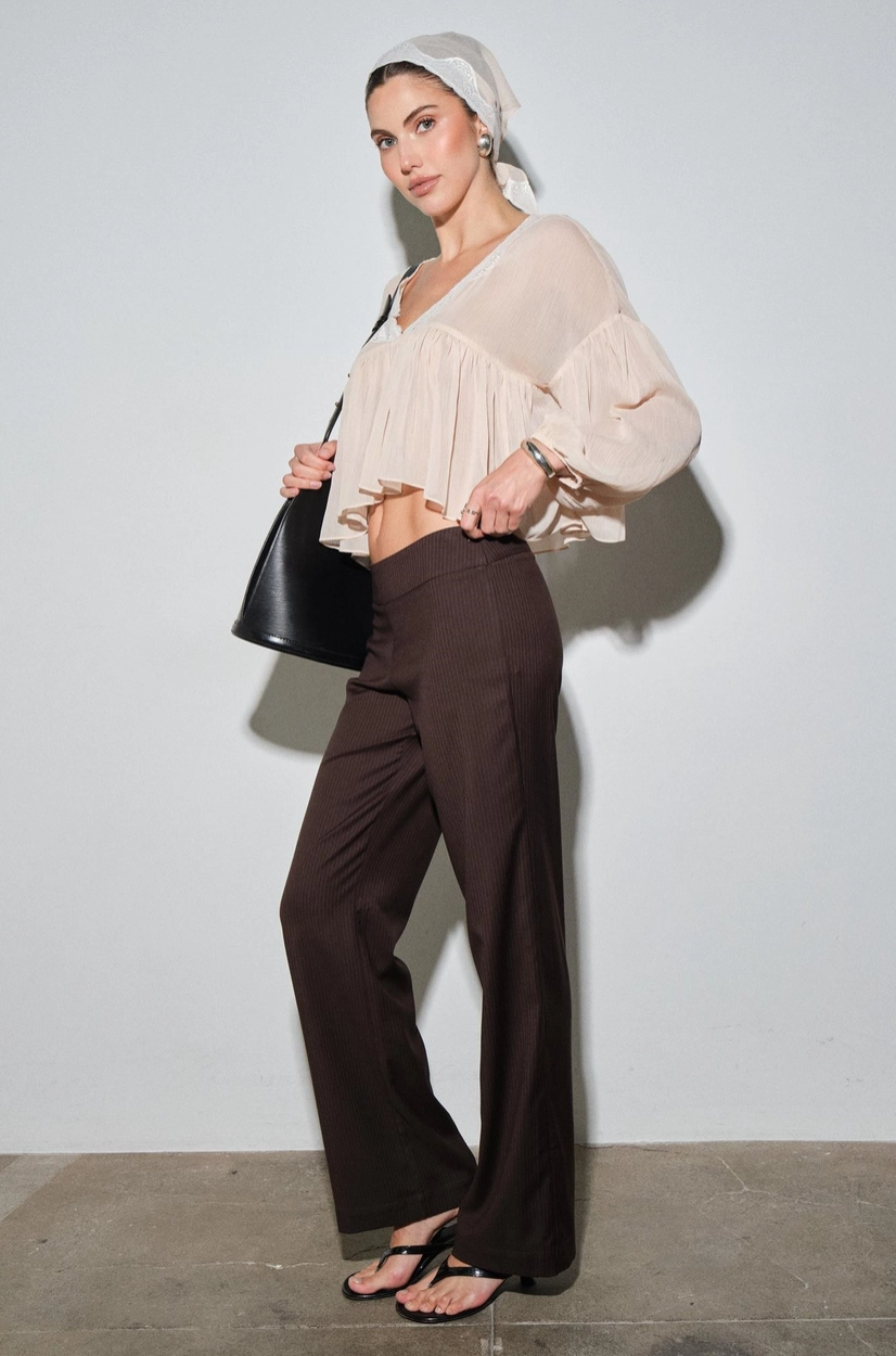 Side view of airy semi sheer chiffon blouse with flutter hem