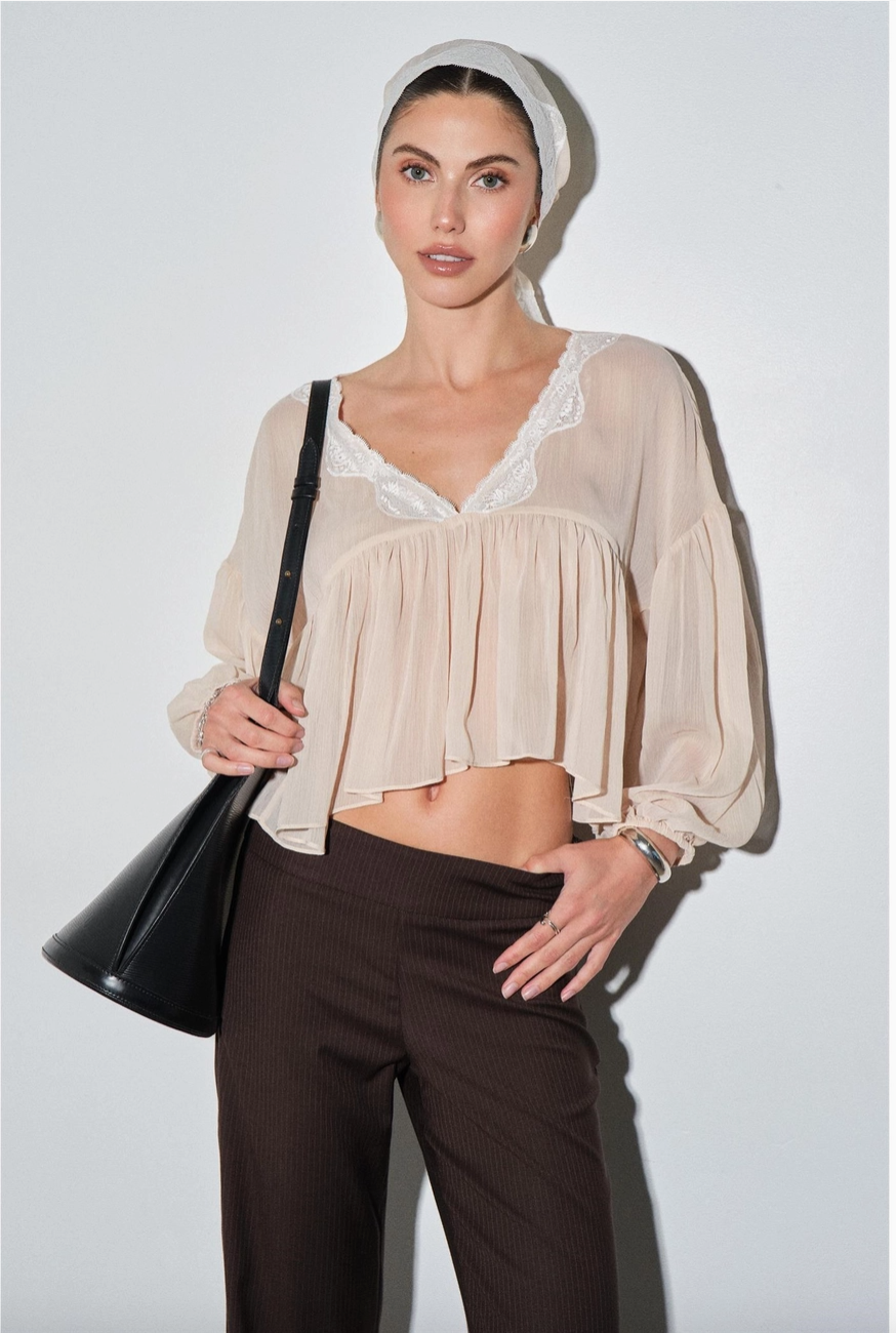 Close up of Colette chiffon blouse with lace V neckline and balloon sleeves with headscarf
