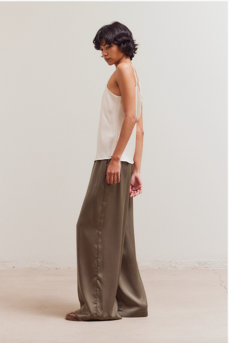 Model wearing The Sienna Satin Palazzo Pant with ivory camisole, showing fluid satin drape and wide leg silhouette