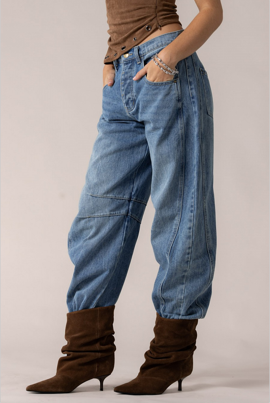 Side view of Cloud Nine barrel jeans showing curved outer seam and slouchy leg volume.
