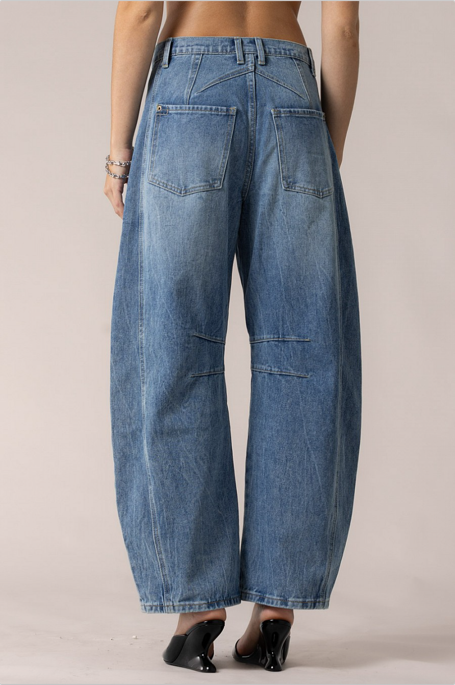 Full back view showing high-rise waist, angled yoke, and roomy barrel-leg silhouette.