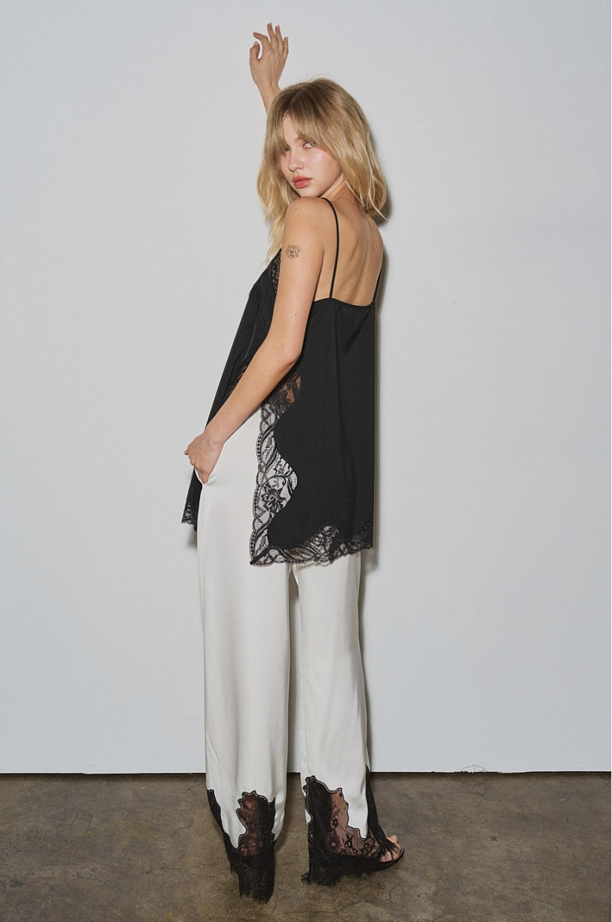 Model wearing Chantilly Satin & Lace Trouser in ivory with black lace hem; Midnight Muse camisole top sold separately (back/side view)