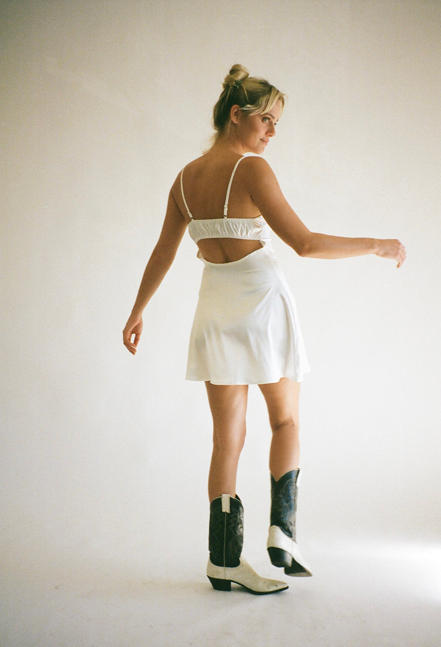 Picture of cut out back detail of pretty slip mini dress with vintage western boots